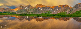 A panoramic photo of the Three Apostles reflected in a tarn at Harrison Flat in the Collegiate Peaks Wilderness, Sawatch Range, Colorado