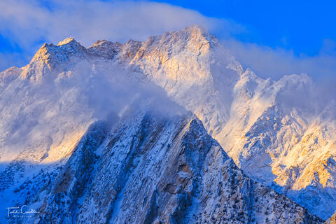 a photo of lone pine peak in the sierra nevada range of california surrounded by clouds
