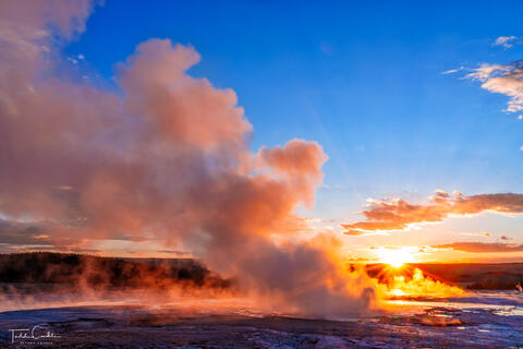 a photo of fountain geyser backlit by the setting sun in yellowstone national park in wyoming.