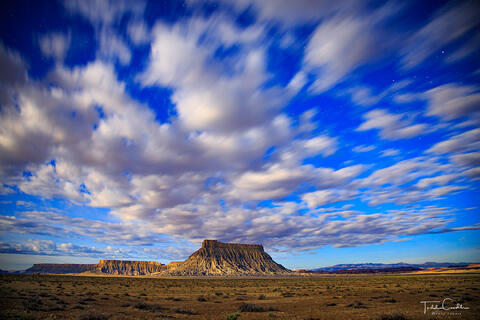 a photo of factory butte utah at night