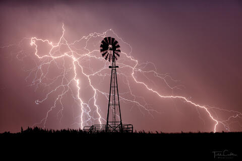 a photo of lightning and a windmill in colorado
