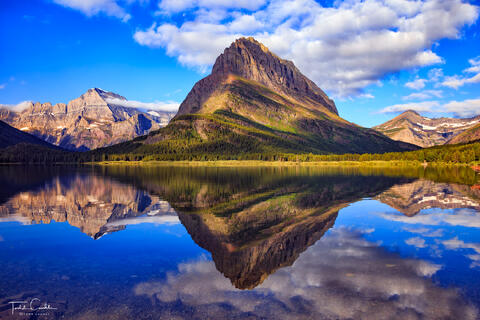 a photo of an incredible reflection at swiftcurrent lake in glacier national park