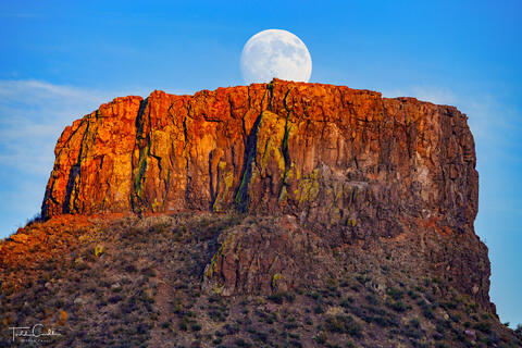 The super moon rises over Castle Rock, a prominent rock outcrop on South Table Mountain in Golden, Colorado.