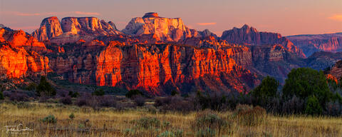 a panoramic photo of some of the dramatic rock formations at sunset at zion national park in utah, as seen from kolob terrace.