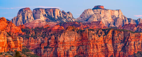 a panoramic photo of some of the dramatic rock formations at zion national park in utah, as seen from kolob terrace.