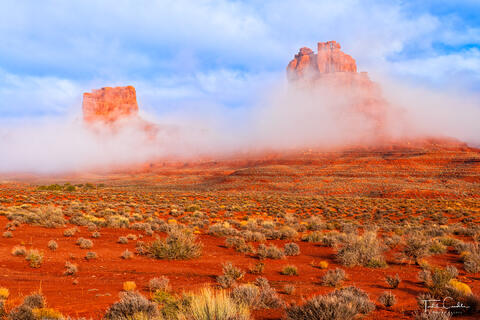 a photo of fog and buttes in valley of the gods in southeastern utah