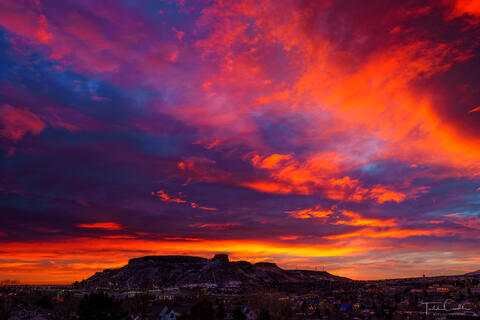 a photo out the bedroom window of a spectacular sunrise over golden, colorado