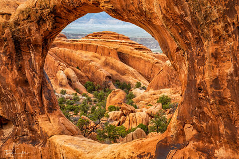 double-o arch frames sandstone fins in arches national park, utah