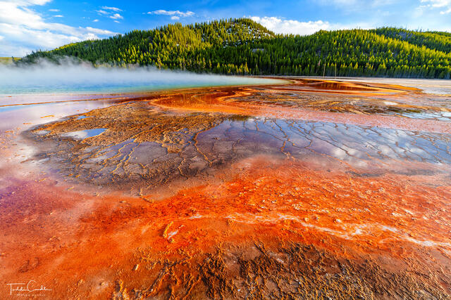 a photo of colorful mineral deposits at grand prismatic hot spring in yellowstone national park in wyoming.