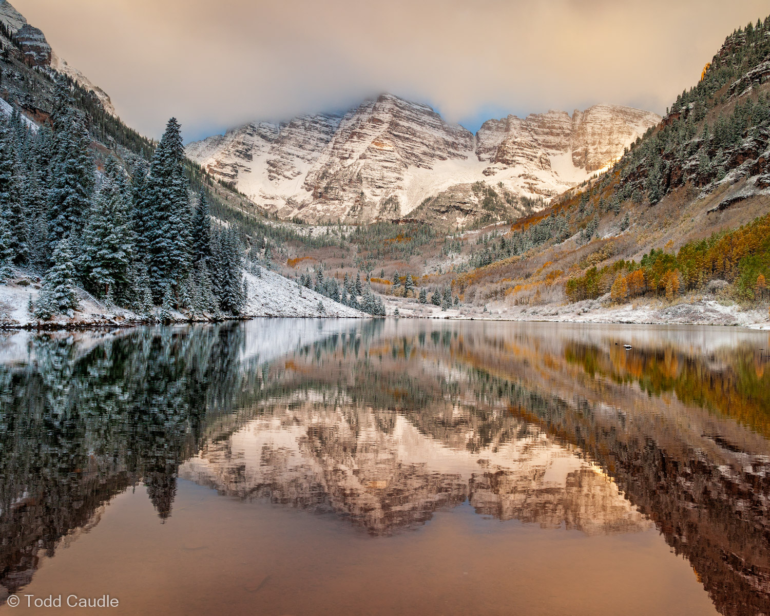 An overnight dusting of snow makes the scene at Maroon Lake, with the famous Maroon Bells reflecting in its calm waters, all...
