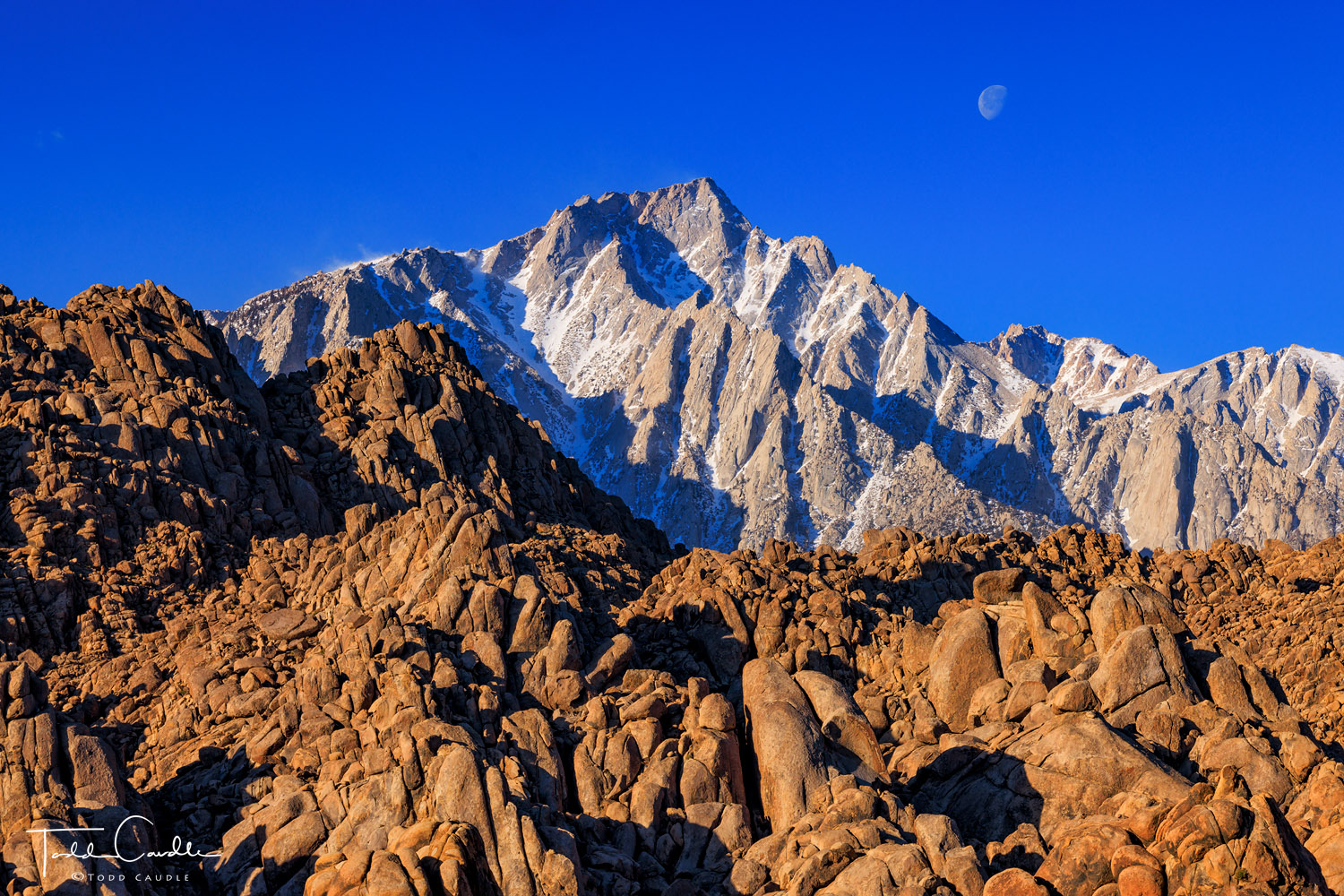 The moon sets over the shoulder of Lone Pine Peak in the Sierra Nevada Range.