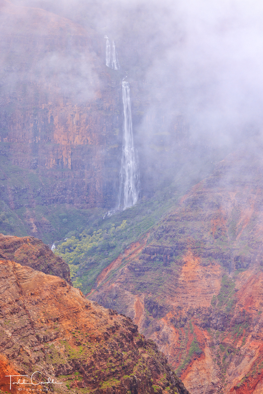 The fog begins to take over the view of Waipo'o Falls in Waimea Canyon State Park. Soon after this image was taken, the falls...