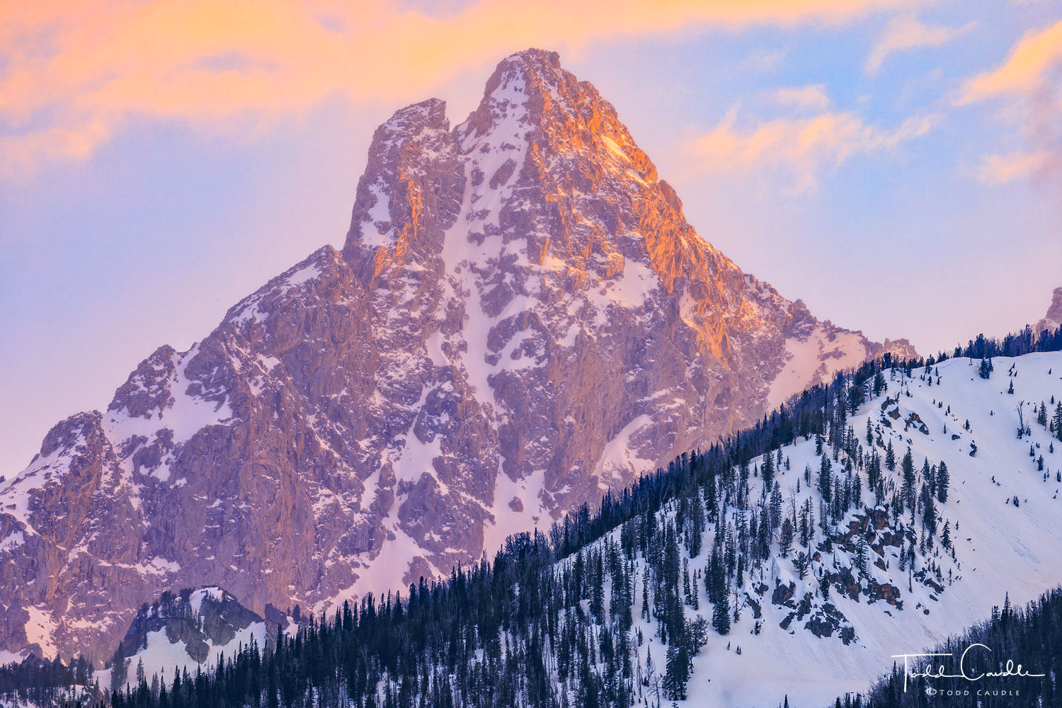 Sunset colors over the mountains of the Teton Range create a spectacular scene.