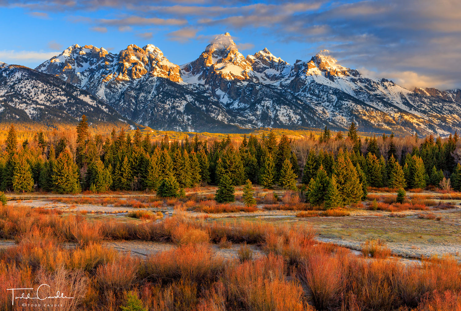 Sunrise over Blacktail Ponds as clouds form over the Grand Teton and the Teton Range.