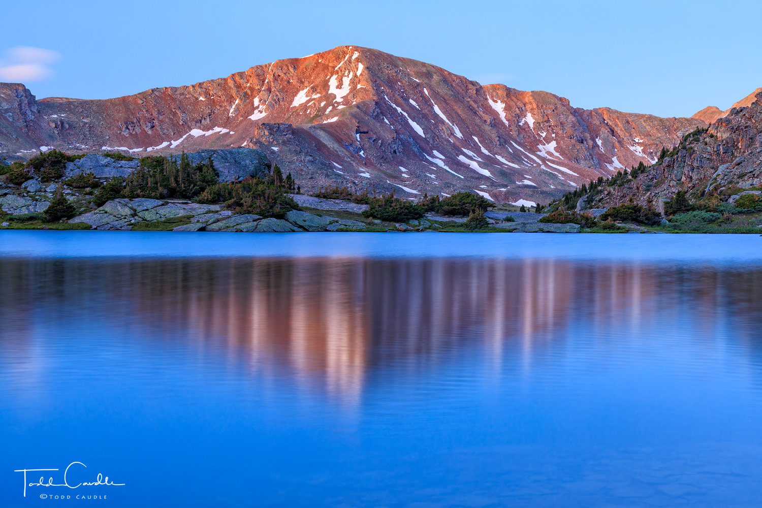 Alpenglow light on Deer Mountain reflects in one of the two North Halfmoon Lakes at sunrise.