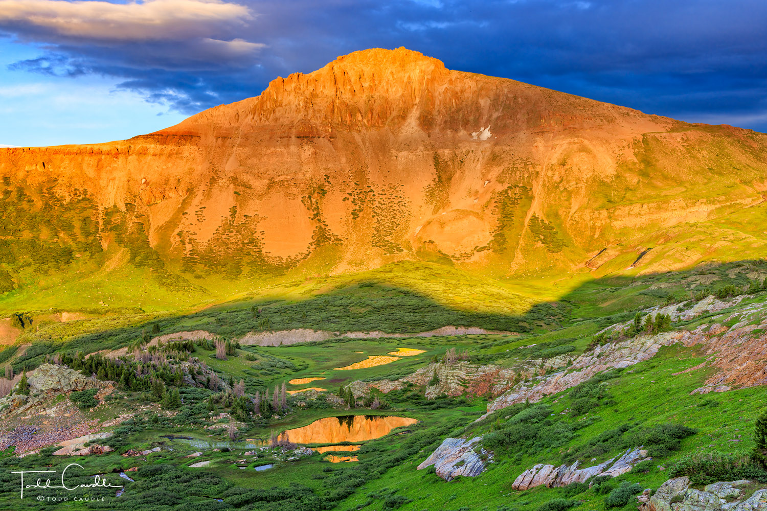 Small tarns in a remote valley reflect sunset light on Ute Ridge in the Grenadier Range.