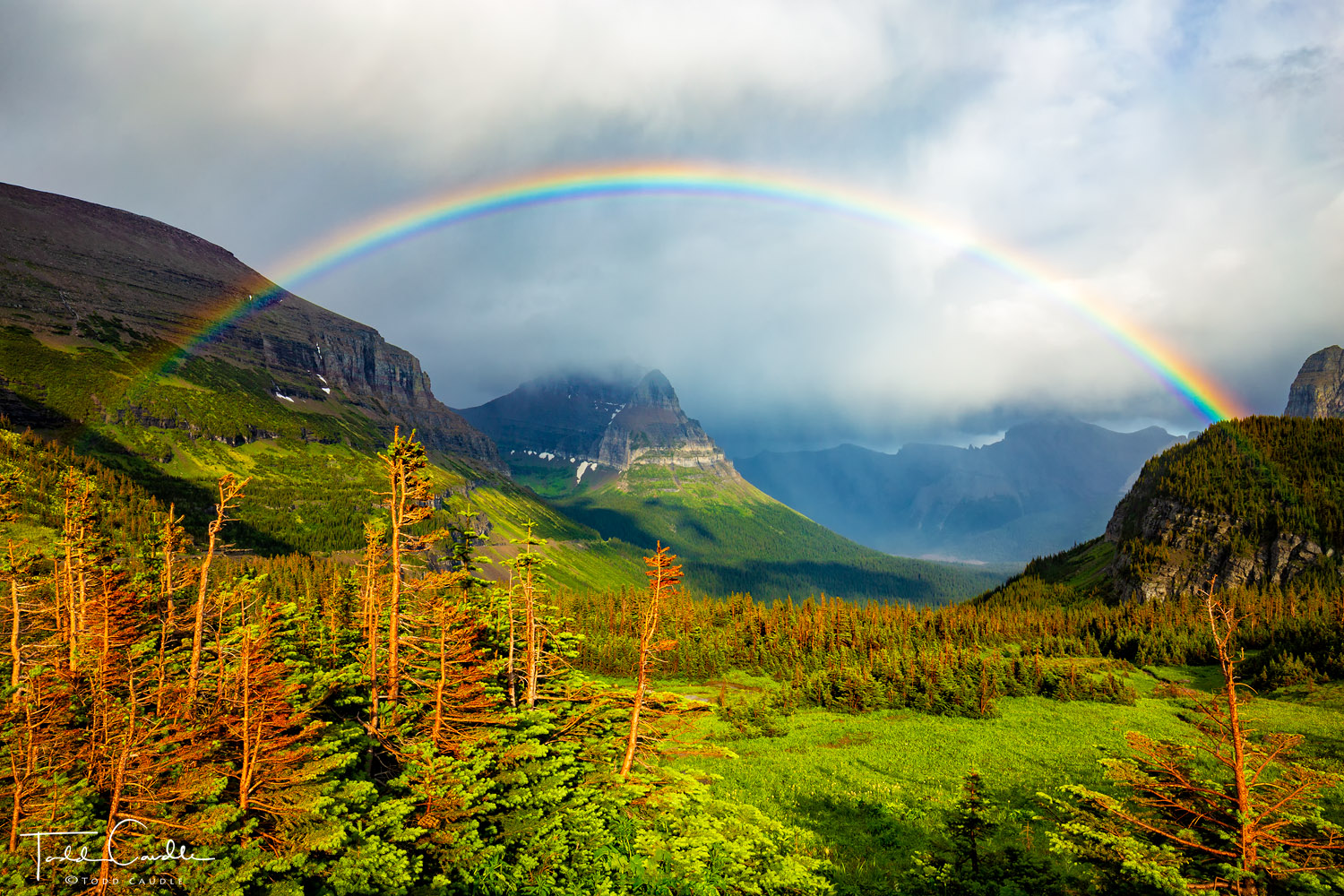 A fast-moving storm leaves a rainbow in its wake on Logan Pass.