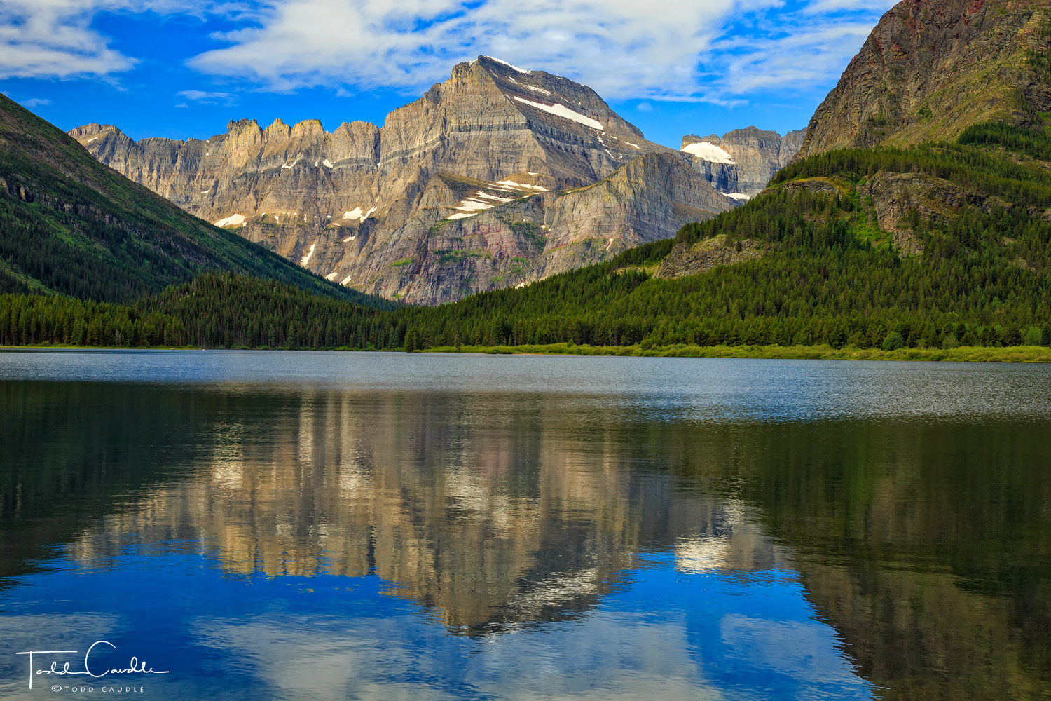 Mount Gould reflects in the still waters of Swiftcurrent Lake in the Many Glaciers region of the park.