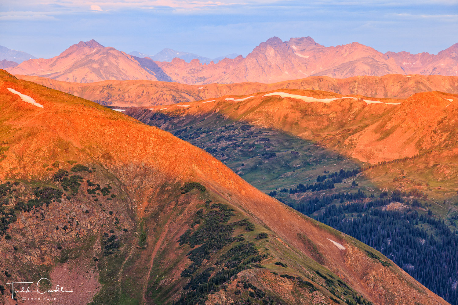 The Gore Range, and a series of peaks and ridges preceding it, catch alpenglow light in this high-altitude view from the Continental...