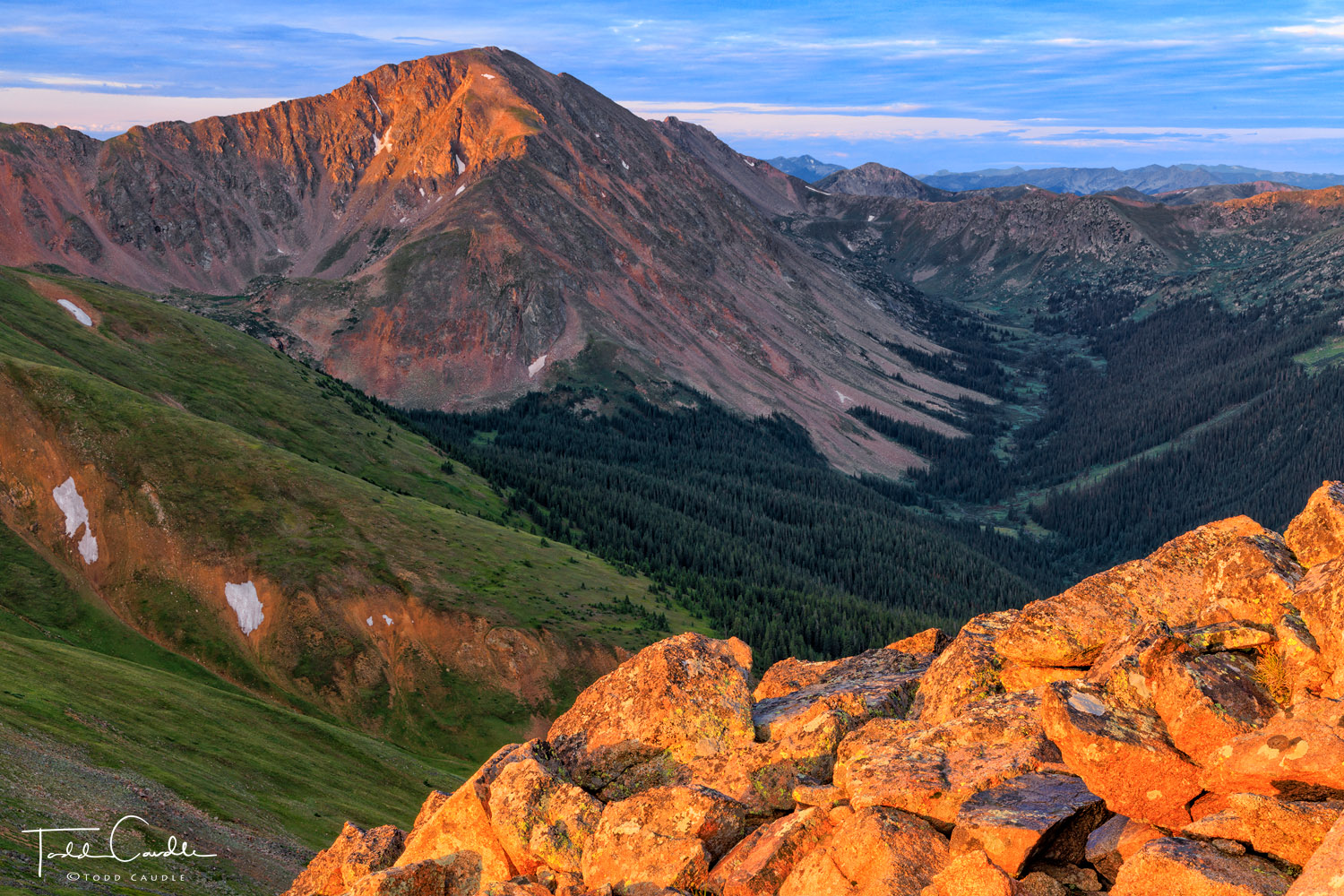 Pettingell Peak catches the first rays of sunrise on Colorado Day, the holiday that celebrates Colorado's entry into the union...