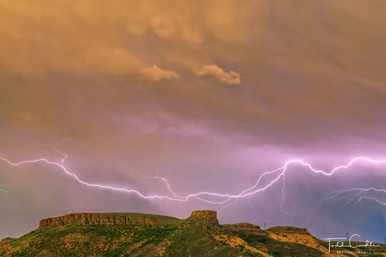 Lightning arcs over Castle Rock and South Table Mountain in Golden.