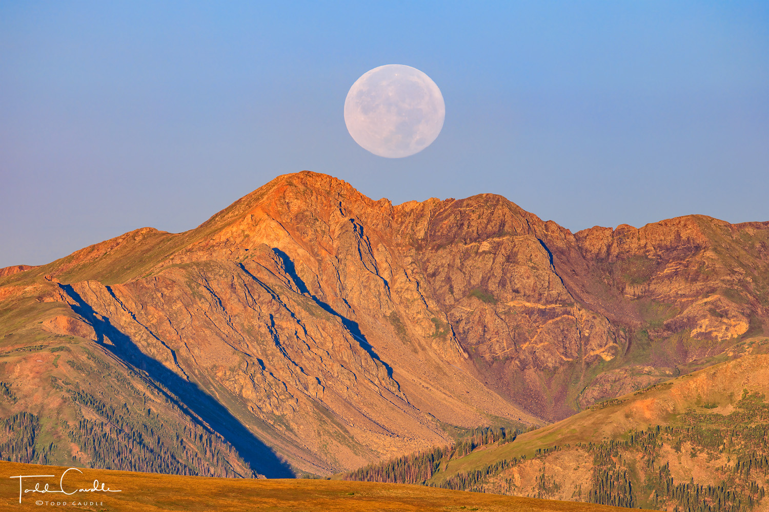 The so-called sturgeon supermoon sets over Bowen Mountain in the Never Summer Range in Rocky Mountain National Park.