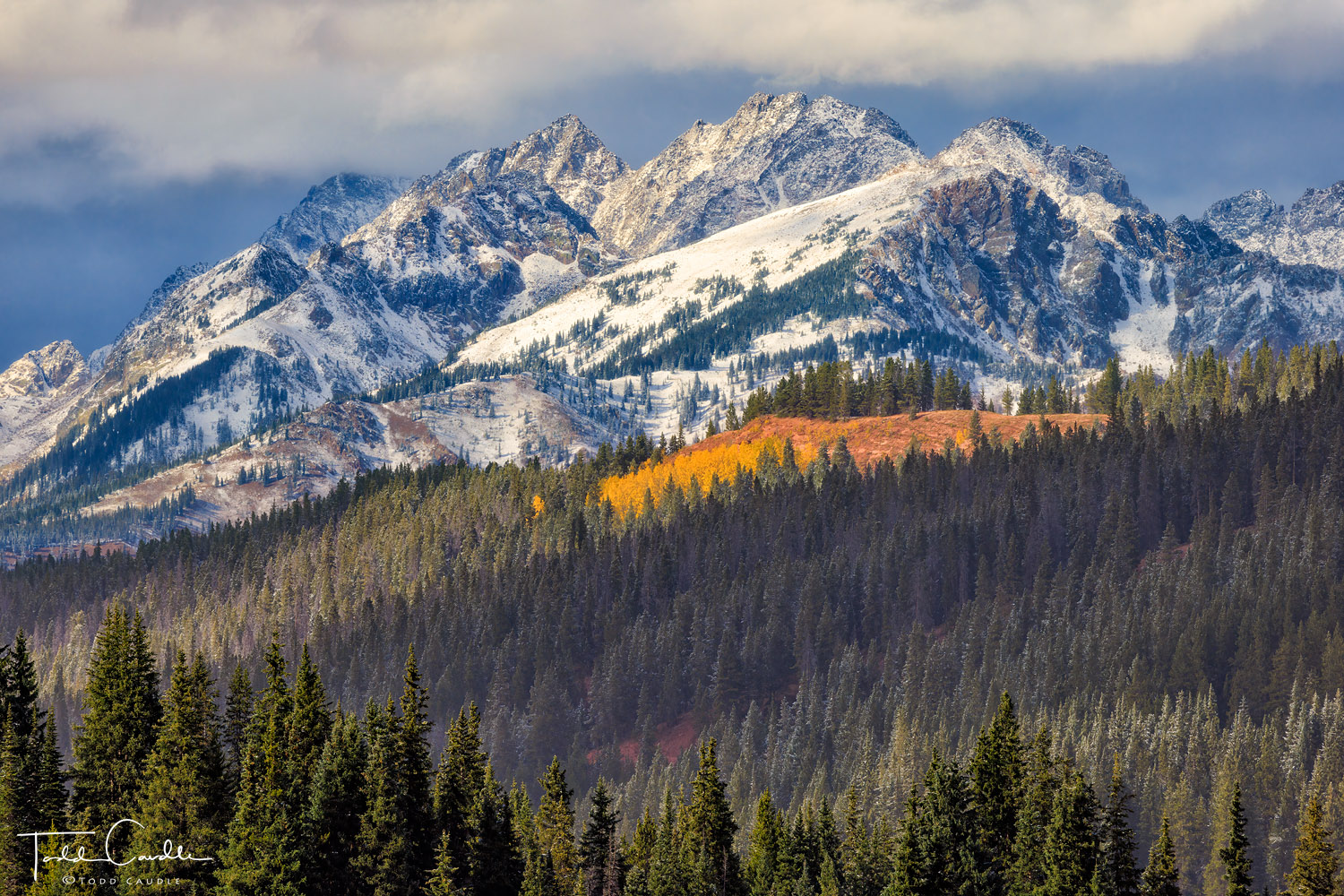An early-season storm begins to clear, and reveals craggy peaks of the Gore Range dusted with the season's first snow.