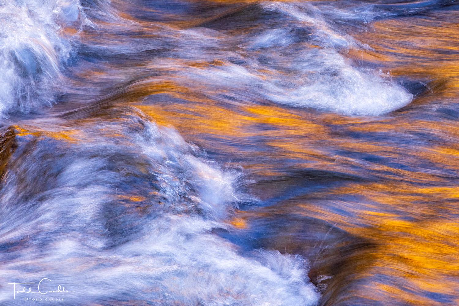 Fall colors reflect in rushing waters of Clear Creek.