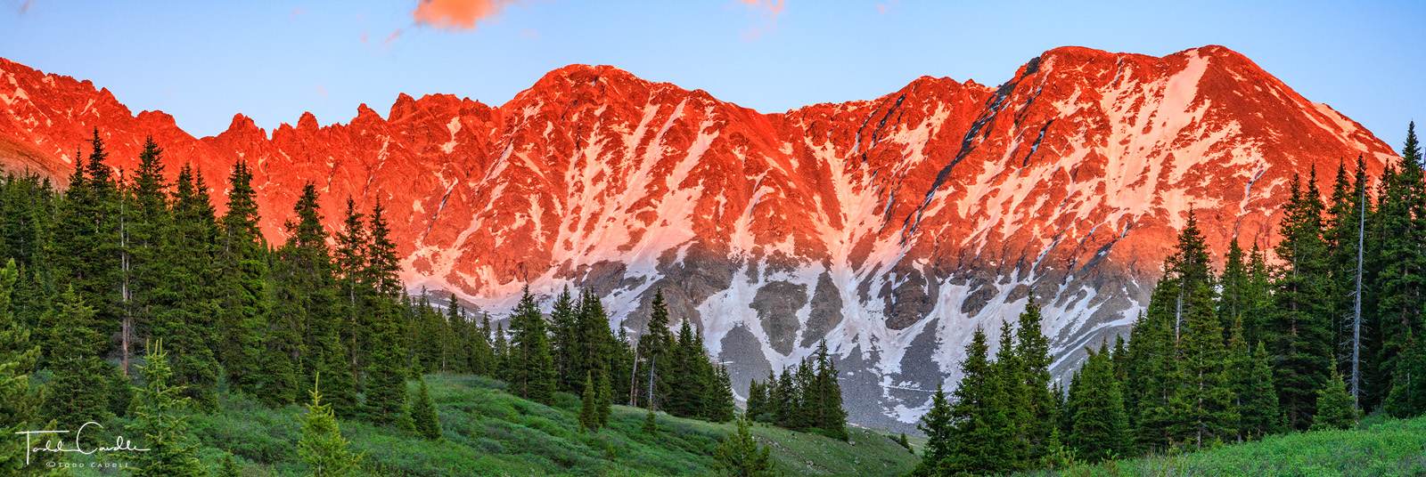 The headwall of Mayflower Gulch in the Tenmile Range basks in the rich alpenglow of a high altitude sunset.